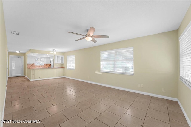 tiled empty room with ceiling fan