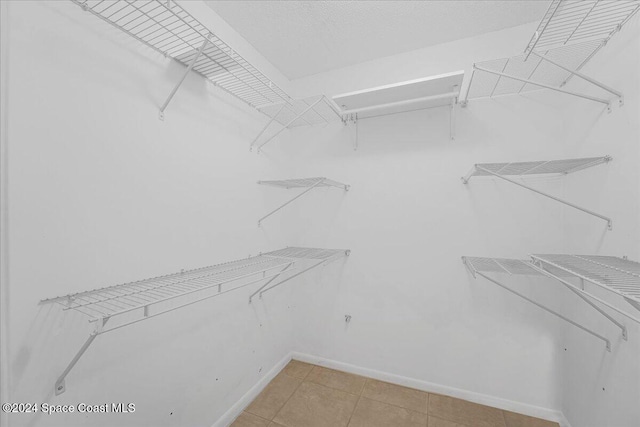 spacious closet featuring light tile patterned flooring