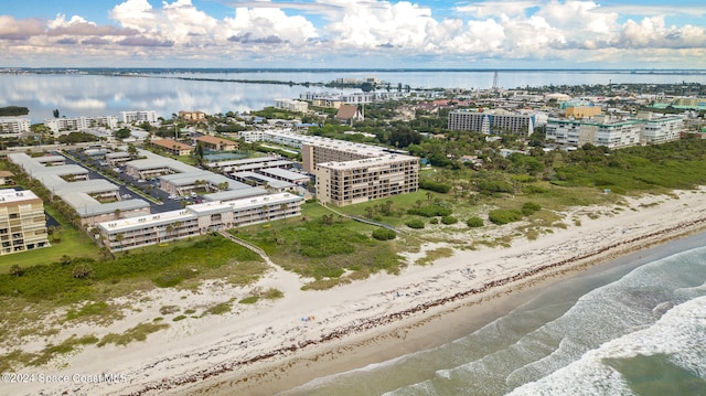 drone / aerial view featuring a view of the beach and a water view