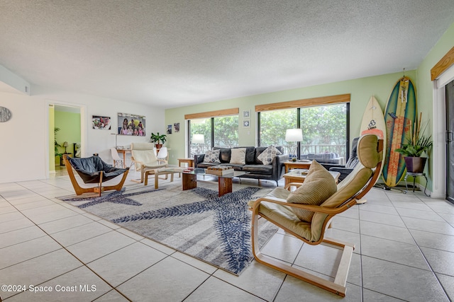 tiled living room featuring a textured ceiling