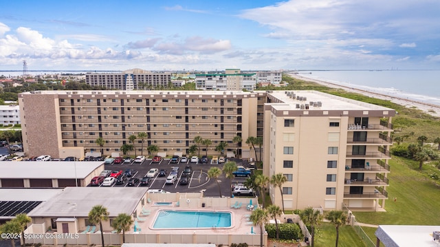 view of building exterior with a view of the beach and a water view