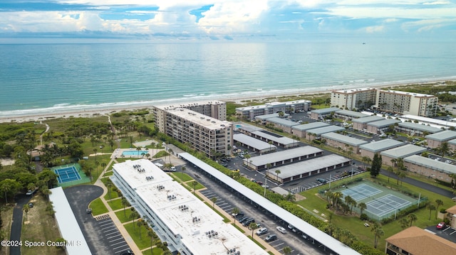 drone / aerial view with a water view and a view of the beach