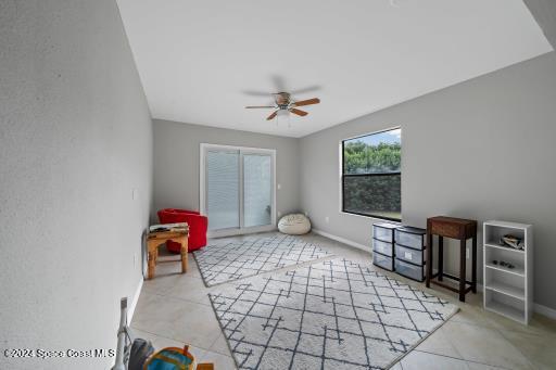 miscellaneous room with ceiling fan and light tile patterned flooring