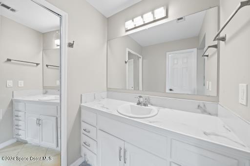 bathroom with tile patterned floors and vanity