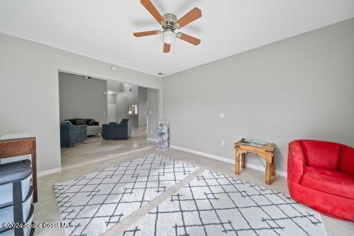 living area with ceiling fan