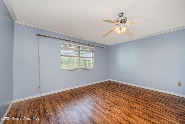 empty room featuring hardwood / wood-style flooring, ceiling fan, and ornamental molding