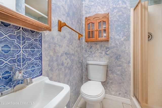 bathroom with tile patterned floors, toilet, and sink