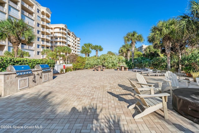 view of property's community featuring a patio area and exterior kitchen