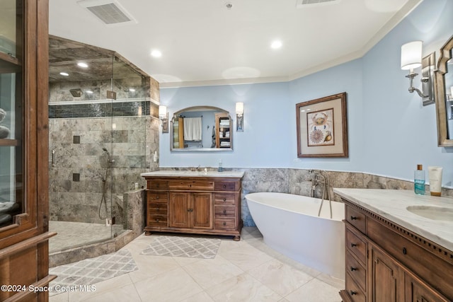 bathroom with separate shower and tub, vanity, and tile walls