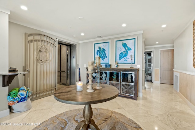 entryway featuring elevator and ornamental molding