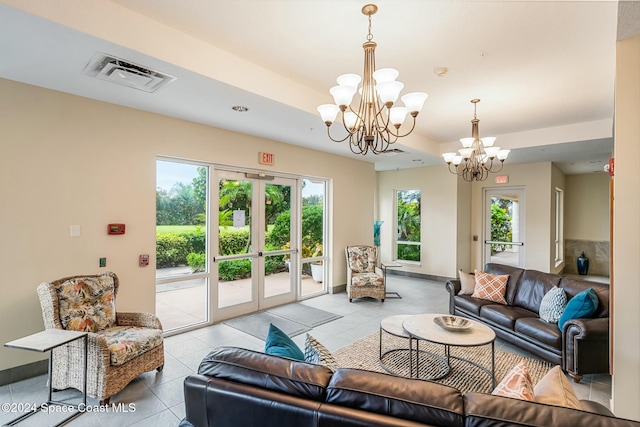 tiled living room with french doors and an inviting chandelier