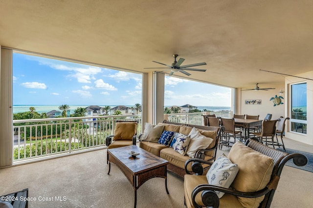 view of patio / terrace with a water view and a balcony