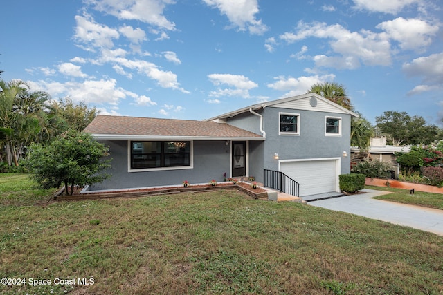 split level home with a front lawn and a garage