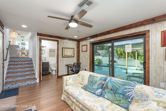 bedroom featuring access to outside, connected bathroom, ceiling fan, and wood-type flooring