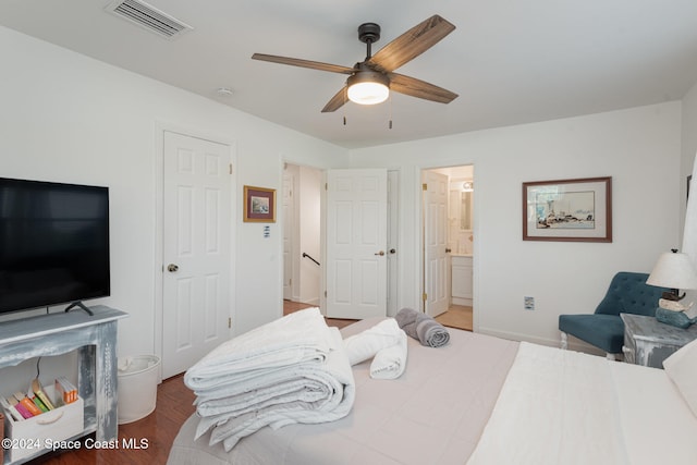 bedroom featuring ceiling fan, ensuite bathroom, and hardwood / wood-style flooring