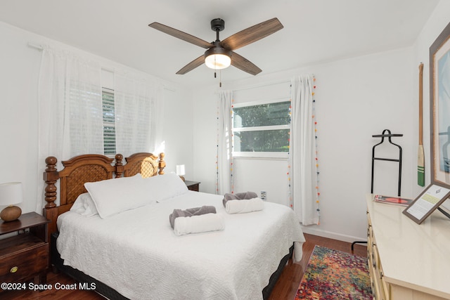 bedroom featuring ceiling fan and dark hardwood / wood-style floors