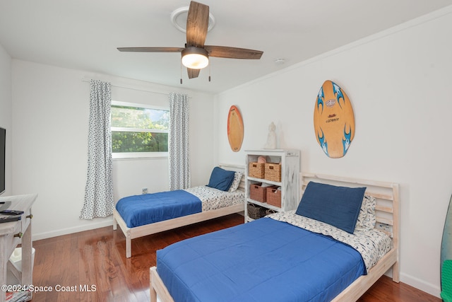 bedroom featuring hardwood / wood-style flooring and ceiling fan