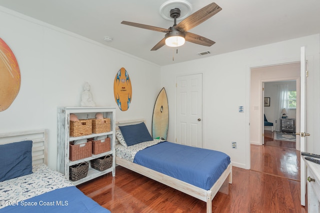 bedroom featuring hardwood / wood-style floors and ceiling fan