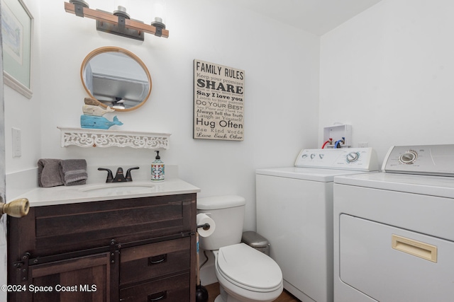 bathroom with vanity, toilet, and independent washer and dryer