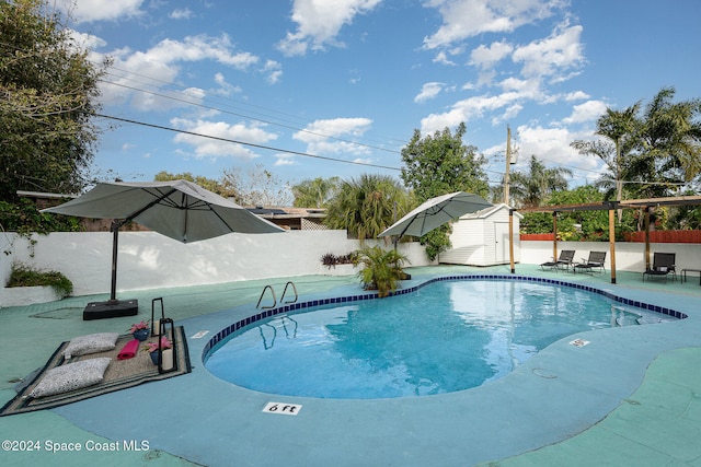 view of pool featuring a shed