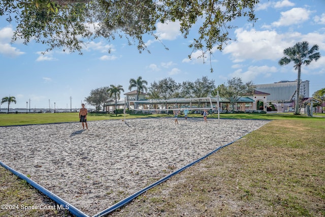 view of property's community with volleyball court and a yard