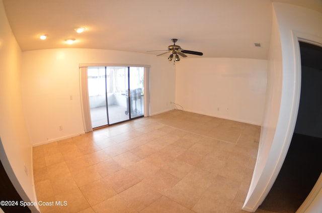 empty room featuring lofted ceiling and ceiling fan