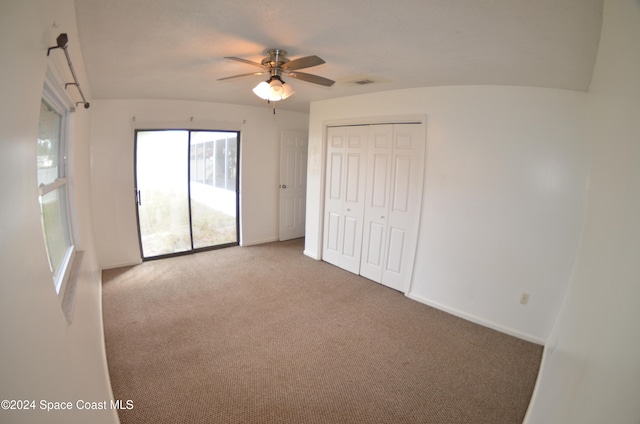 unfurnished bedroom with carpet floors, ceiling fan, and a closet