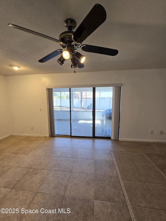 spare room featuring ceiling fan and a textured ceiling