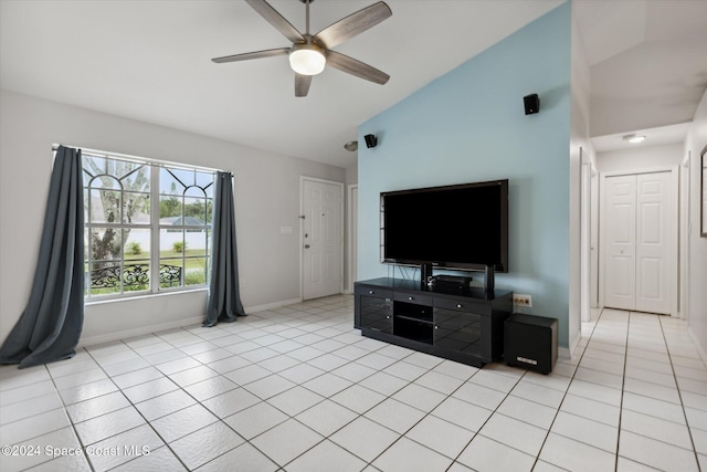 tiled living room with ceiling fan and vaulted ceiling