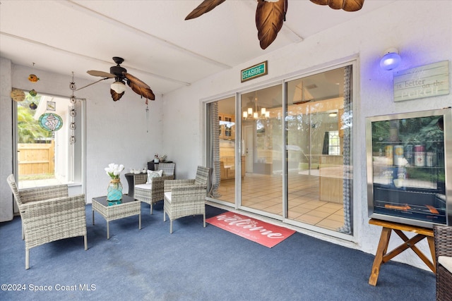 exterior space with ceiling fan and beverage cooler