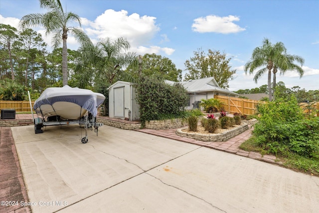 view of patio / terrace featuring a storage unit