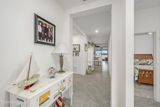 hall featuring light tile patterned floors