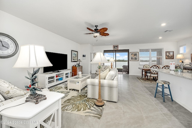 tiled living room featuring ceiling fan