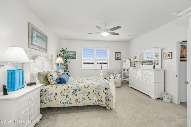 bedroom with ceiling fan, light carpet, and multiple windows