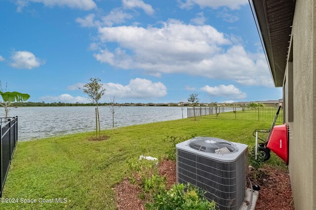 view of yard featuring cooling unit and a water view