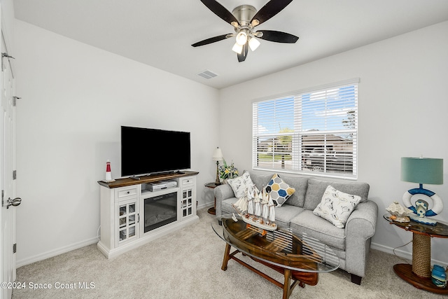 carpeted living room with ceiling fan