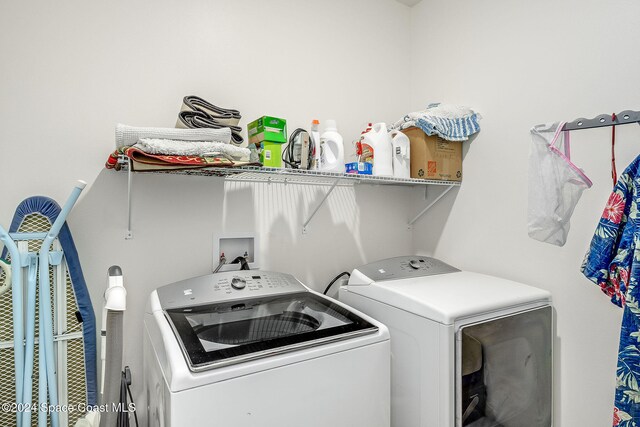 clothes washing area with washer and clothes dryer