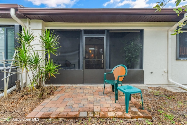 view of patio / terrace featuring a sunroom and cooling unit