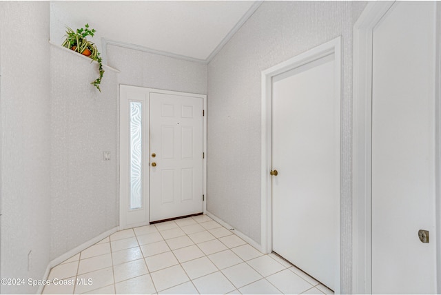 entryway featuring crown molding, plenty of natural light, and light tile patterned floors