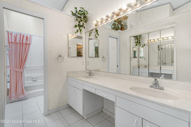 bathroom featuring tile patterned flooring, shower / bath combo, and vanity