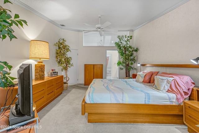 bedroom with light carpet, ceiling fan, and ornamental molding