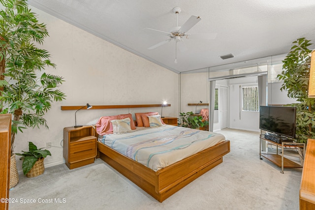 bedroom featuring a textured ceiling, light colored carpet, ceiling fan, and crown molding