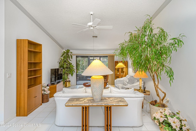 living room with ceiling fan, crown molding, light tile patterned flooring, and a textured ceiling