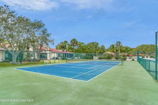 view of tennis court featuring basketball hoop