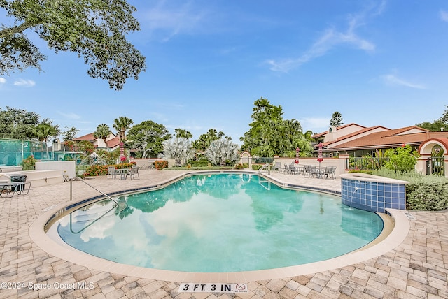 view of swimming pool with a patio area