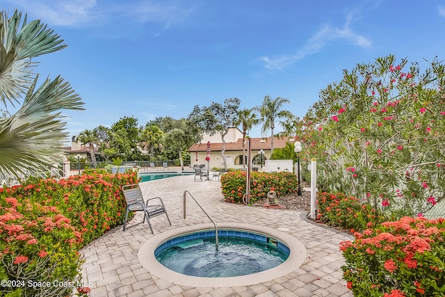 view of pool with a patio area and a community hot tub