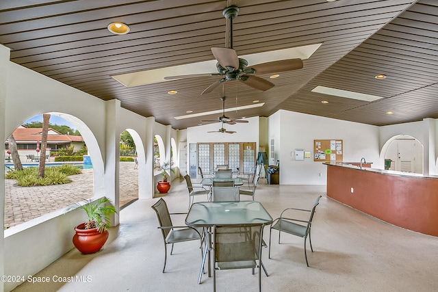 view of patio featuring ceiling fan and sink