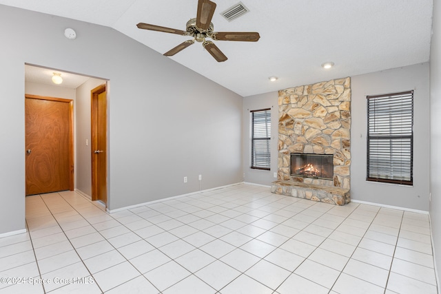 unfurnished living room with ceiling fan, a fireplace, light tile patterned flooring, and lofted ceiling