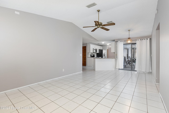 unfurnished living room featuring ceiling fan, light tile patterned floors, and vaulted ceiling