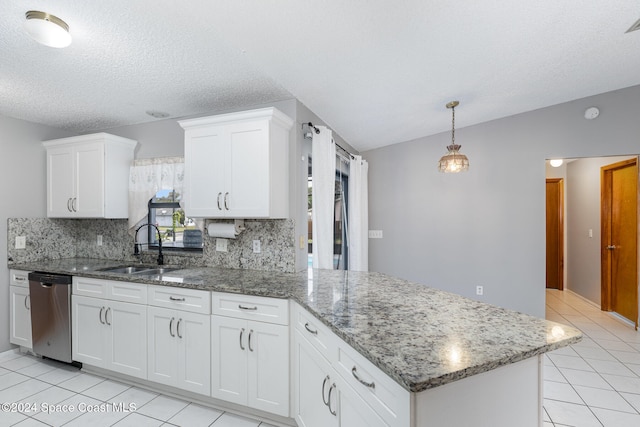 kitchen featuring white cabinets, decorative backsplash, stainless steel dishwasher, and sink